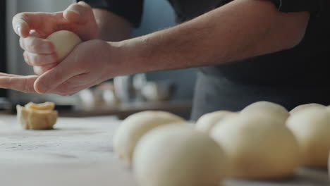 baker making dough balls