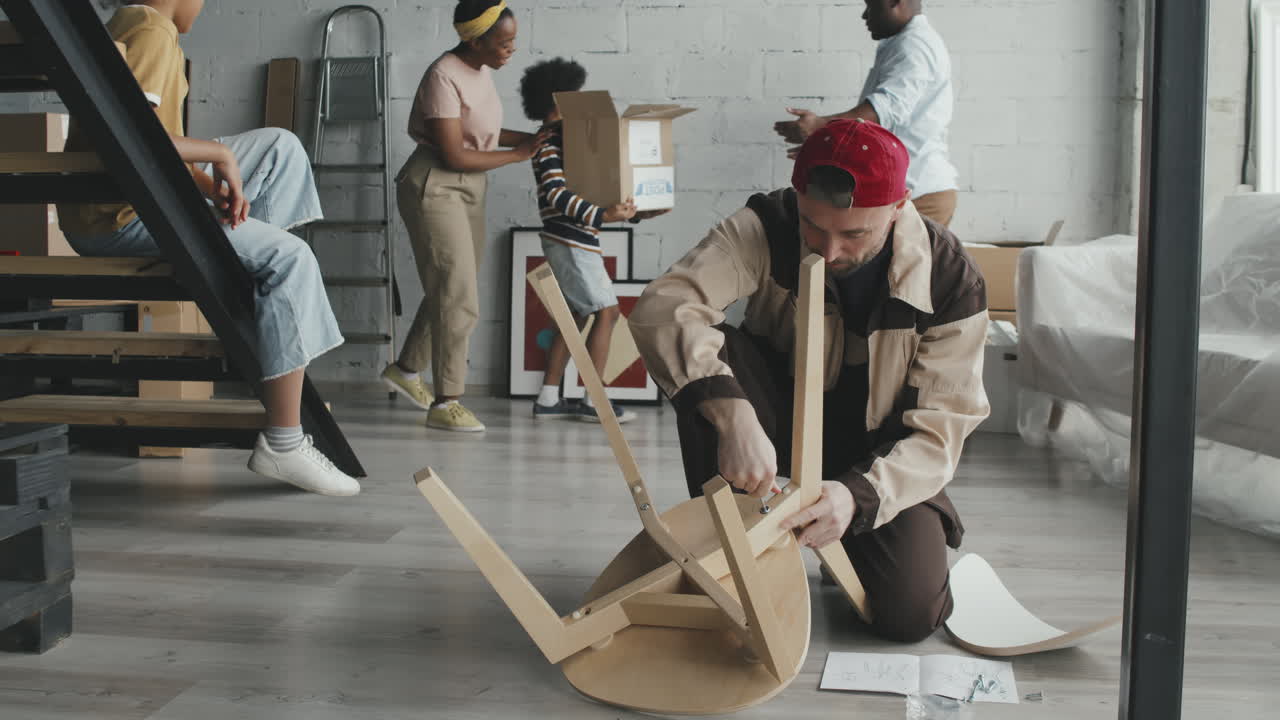 Family moving into new home assembling furniture