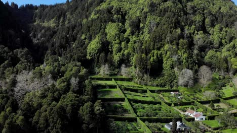 4K-aerial-footage-over-a-mountain-cliff-and-the-surrounding-mountains-at-São-Miguel-island,-Azores,-Portugal