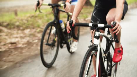 cropped shot of athletes riding bicycles