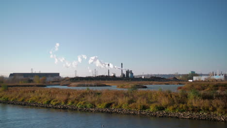Factories-spewing-smoke-in-the-distance-from-wetlands