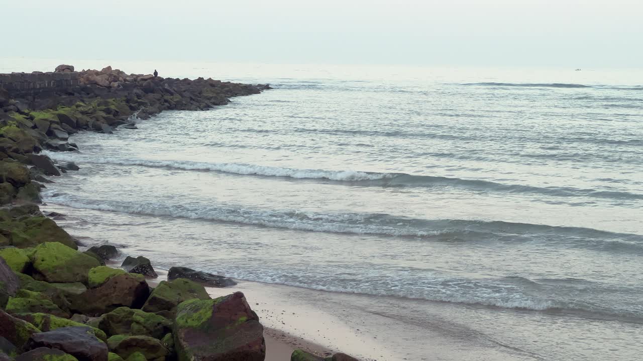 Static view of the sea near a cove with stone rocks: Daylight