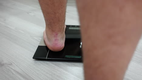 measuring weight on weighing scale, close up