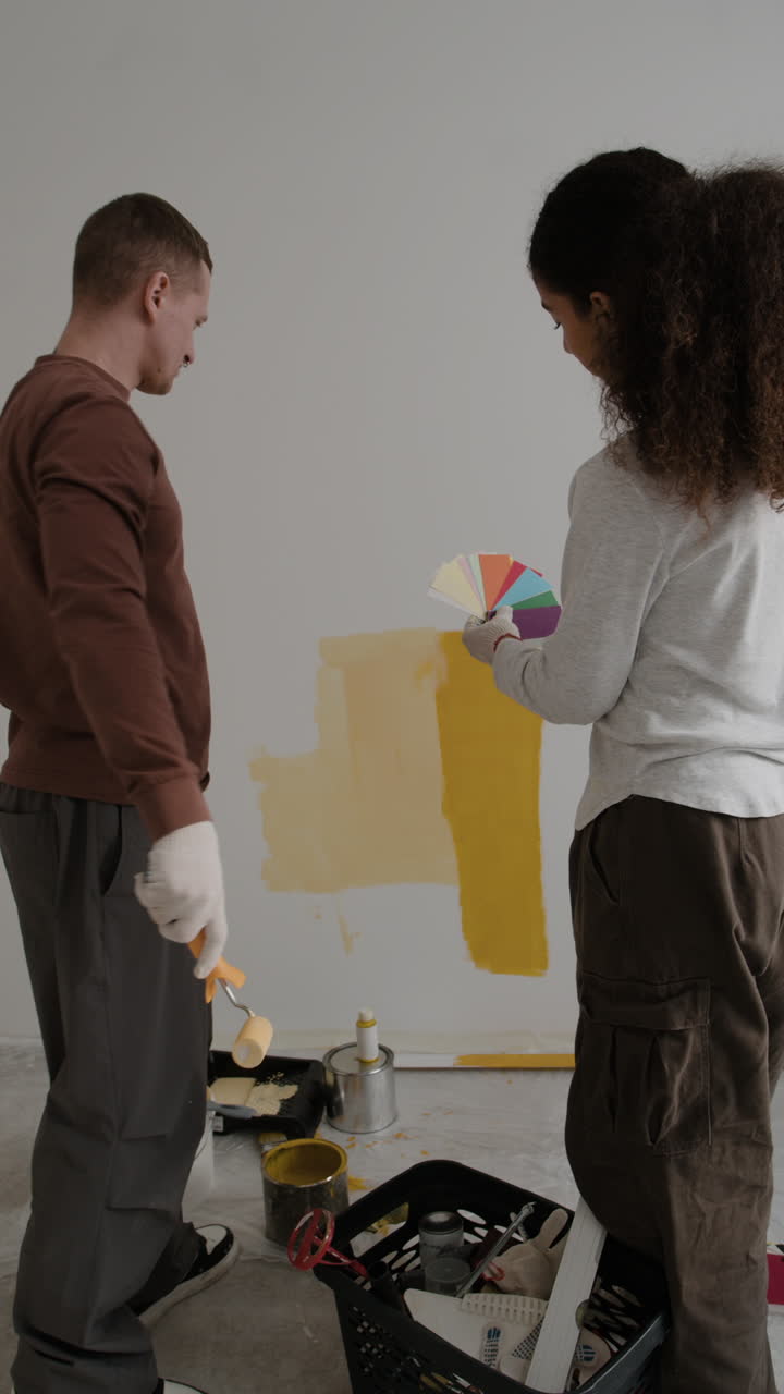 pareja pintando una pared juntos