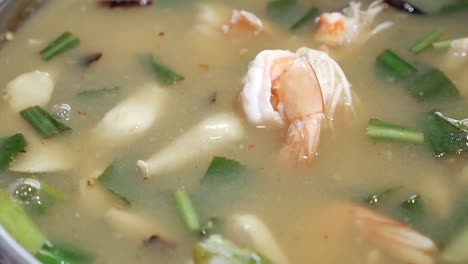 close up footage of thai style clear tom yum kung soup, spicy and sour prawn soup