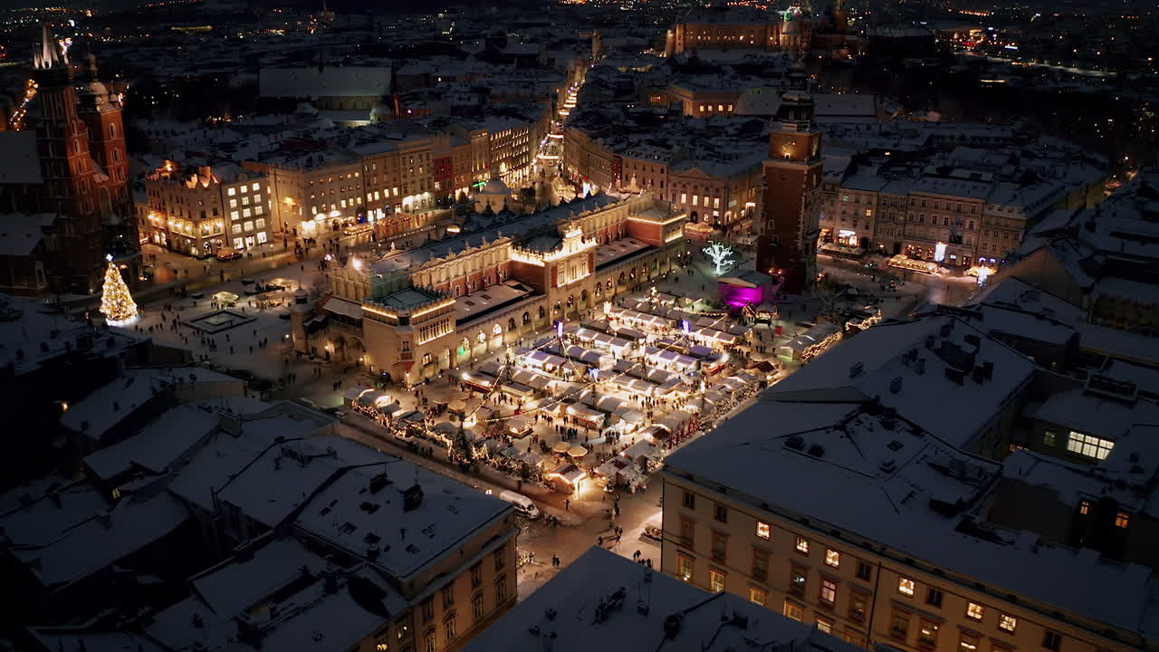 Aerial view of snow covered Christmas stalls at night on the Main Market Square in Krakow, Poland