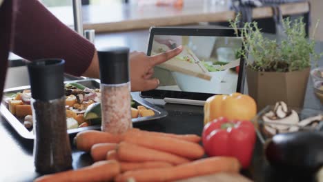 close up of african american plus size woman chopping vegetables in kitchen, slow motion