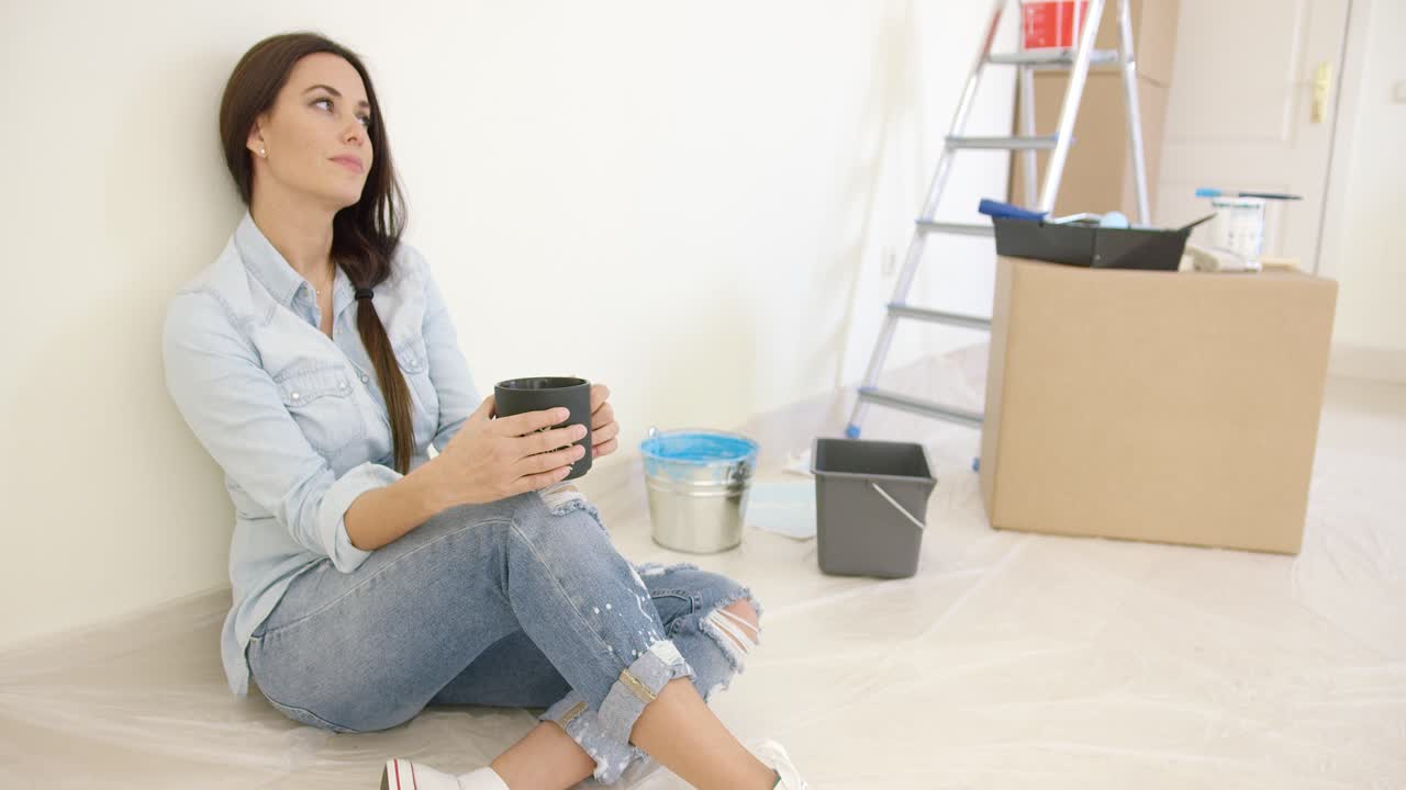 Pretty young woman relaxing while renovating