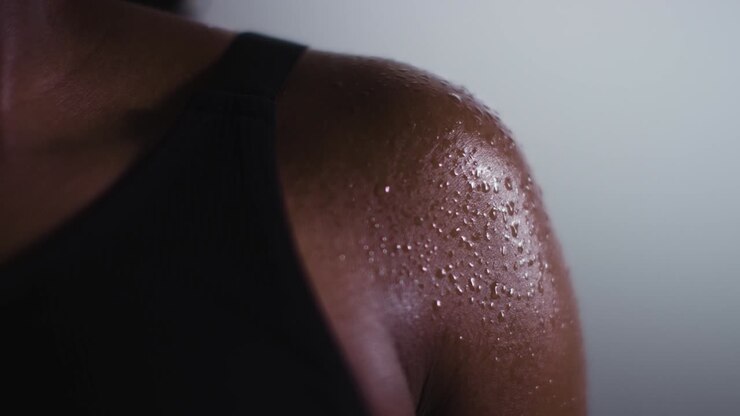 Close Up Shot Of Beads Of Sweat On Woman Wearing Gym Fitness Clothing Exercising 3