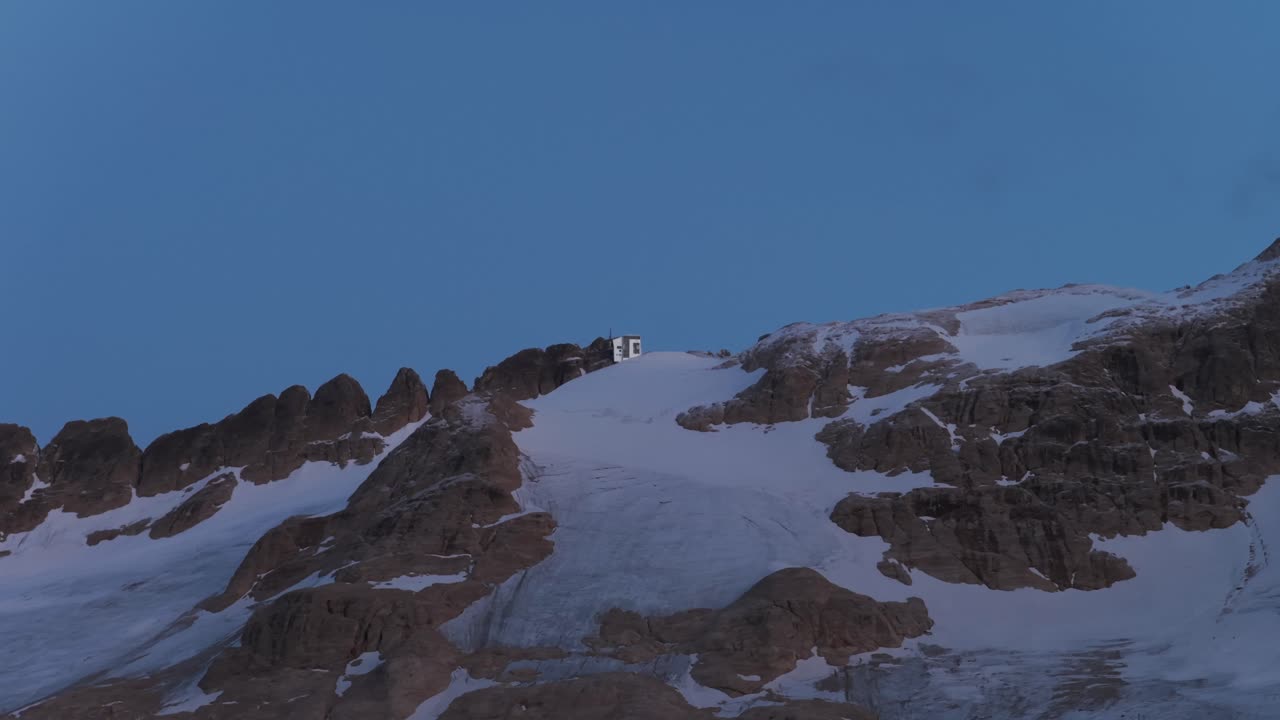Marmolada glacier and Punta Rocca station at twilight, Dolomites, Italy. Aerial drone, copy space