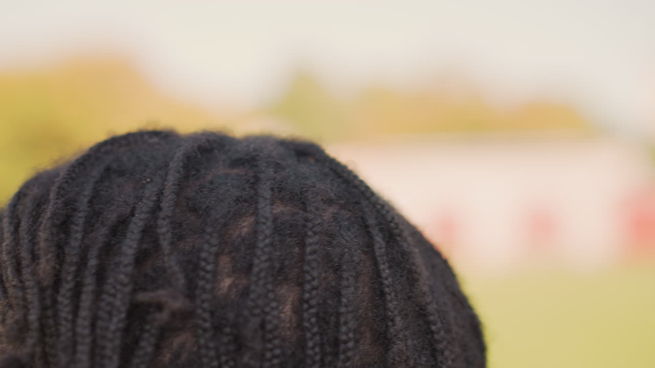 Black Man Adjusting Dreadlocks Outdoors CloseUp, Hands Parting Roots And Styling Textured Hair In Warm Sunlight, Intimate Grooming Ritual Showing Focus, Confidence And Cultural Identity