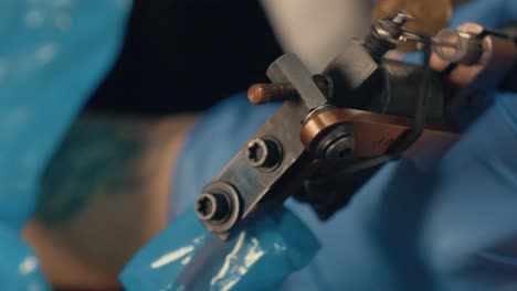 close-up shot of a tattoo gun vibrating continuously while working