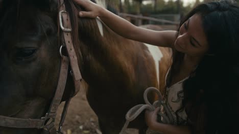 woman gently petting a horse at a ranch