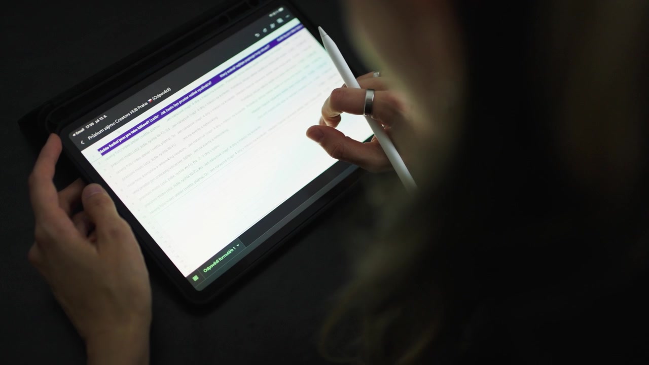 Person works on a tablet, close up view