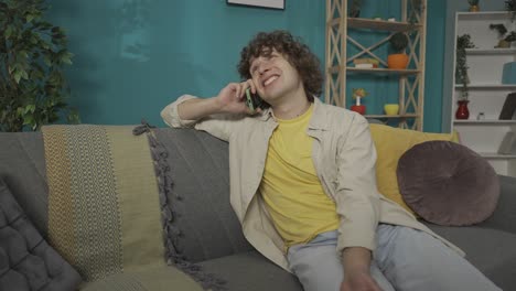 young man talking on phone at home