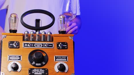 old retro am fm radio with tubes, hand changing stations , bulb vintage music player.