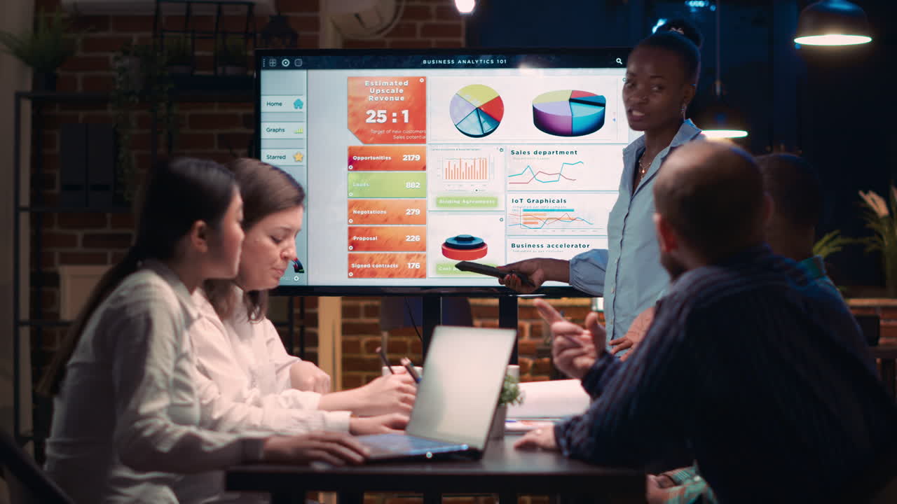 African american business coach giving analytics presentation in meeting