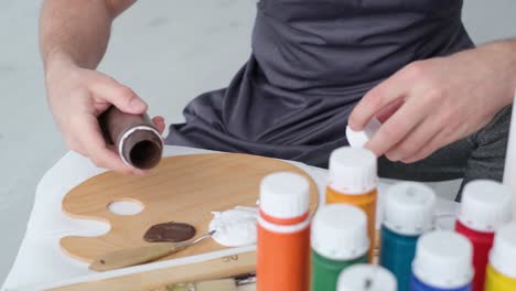 male artist paints a picture with oil paints artist while working in the studio male artist paints a picture with oil paints artist while working in the studio painting an art picture