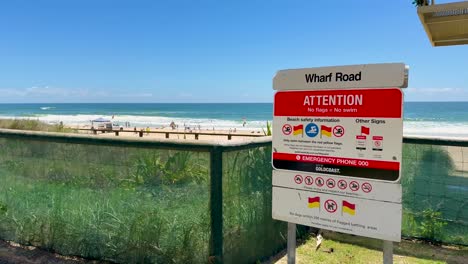 signage with beach and ocean in background