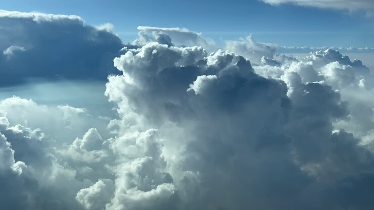 POV flying though a stormy sky full of threatening clouds as seen by the pilots of a jet from the cockpit