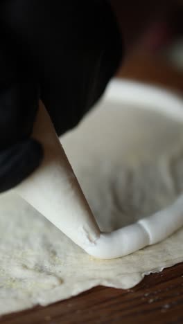 piping cream onto dough