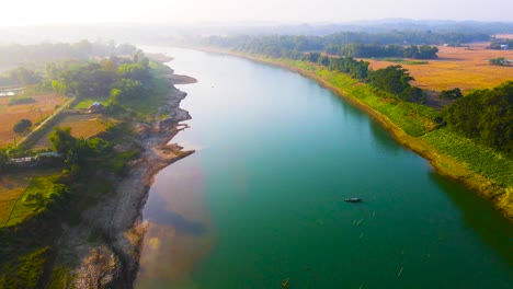 rural scenery with view on the surma river in bangladesh - aerial drone shot