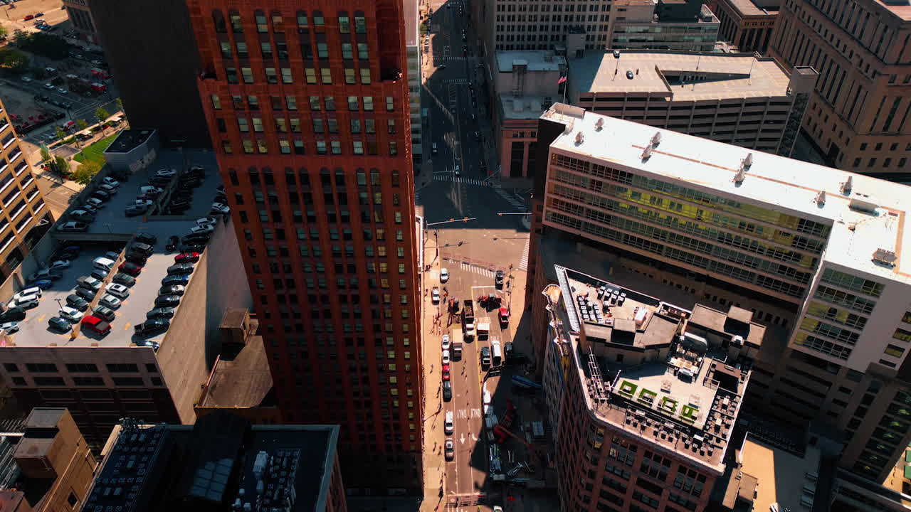 Detroit, USA, 28 July 2025: Amazing David Scott Building in downtown Detroit, Michigan, USA. Aerial perspective on the Art Deco style high-rise. Multiple cars are parked on the roof of next building