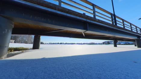 Slow-Motion-Footage-of-Bridge-Column-Trapped-by-Frozen-River-Ice-On-A-Sunny-Winter-Day