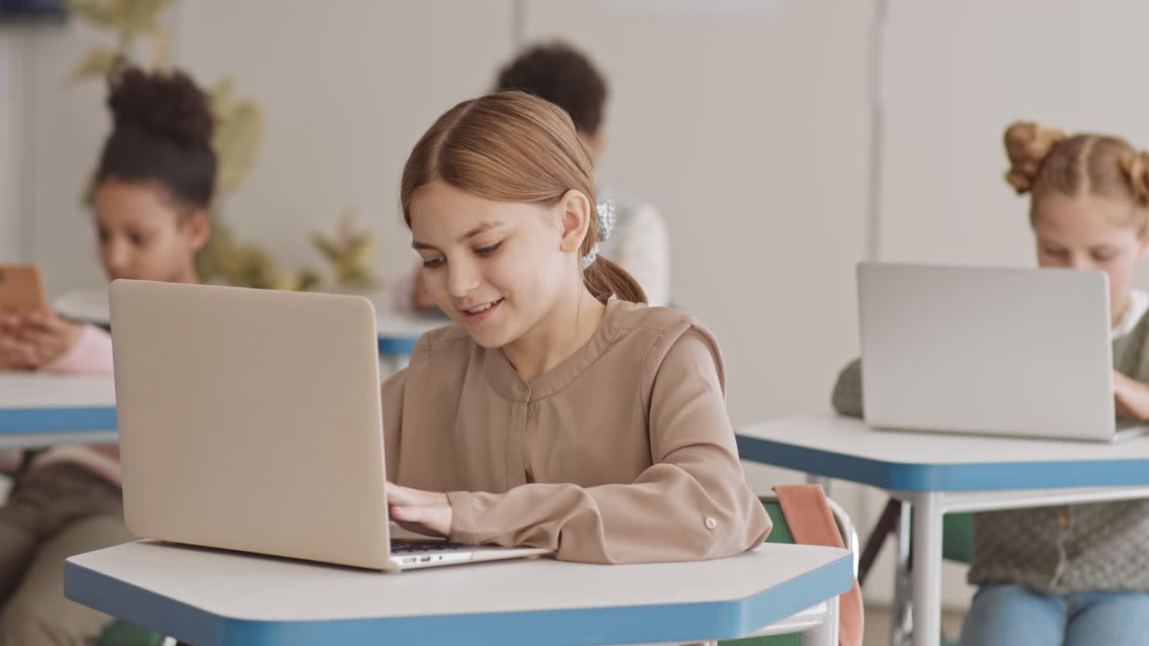 Schoolgirl Studying on Laptop in Class