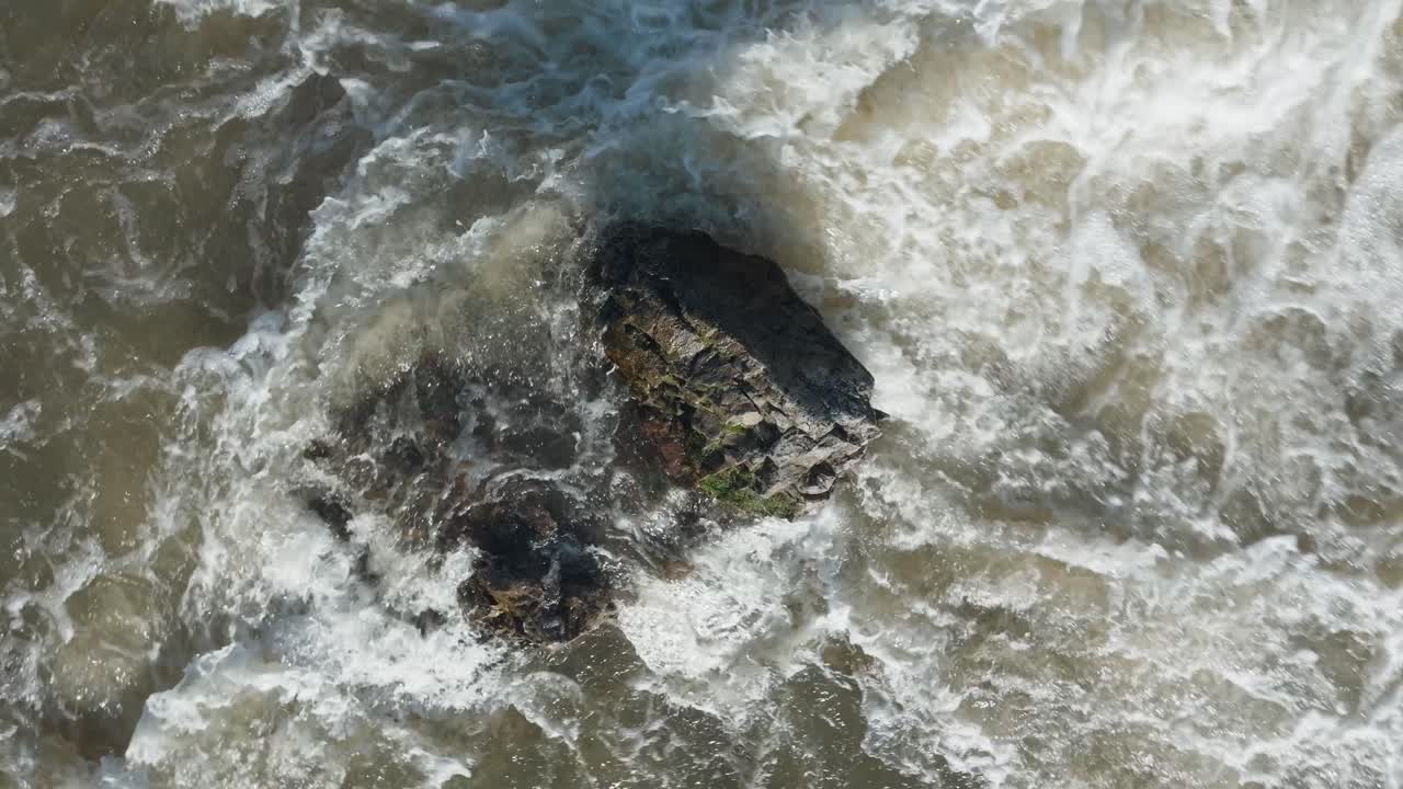 Turbulent waterfall cascading over rocks in owen sound, canada, aerial view