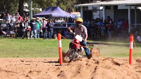 rider navigating sandy obstacle course with spectators