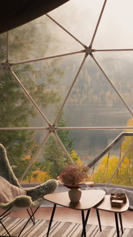 lunch space on glamping house terrace for tourists. low table with soft chairs around to enjoy enchanting view of lake. glamping hotel room for rent