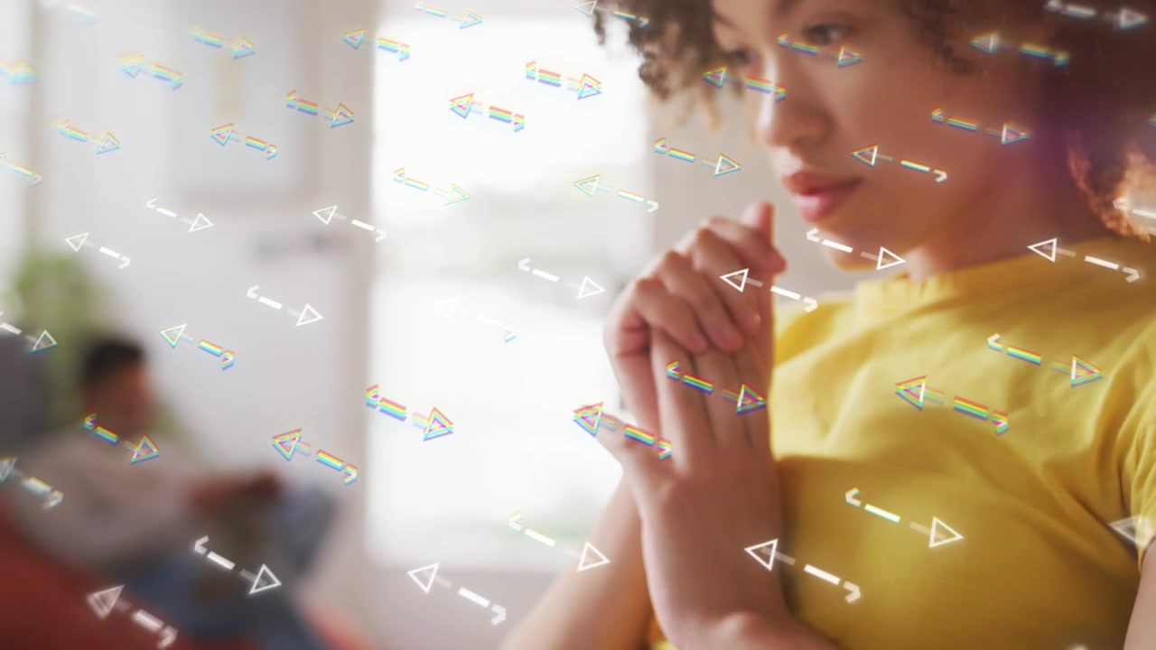 Woman stopping typing on laptop in tech work, clasping, reflecting as triangles floating over lap