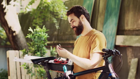 man grasping toolkit for fixing bicycle