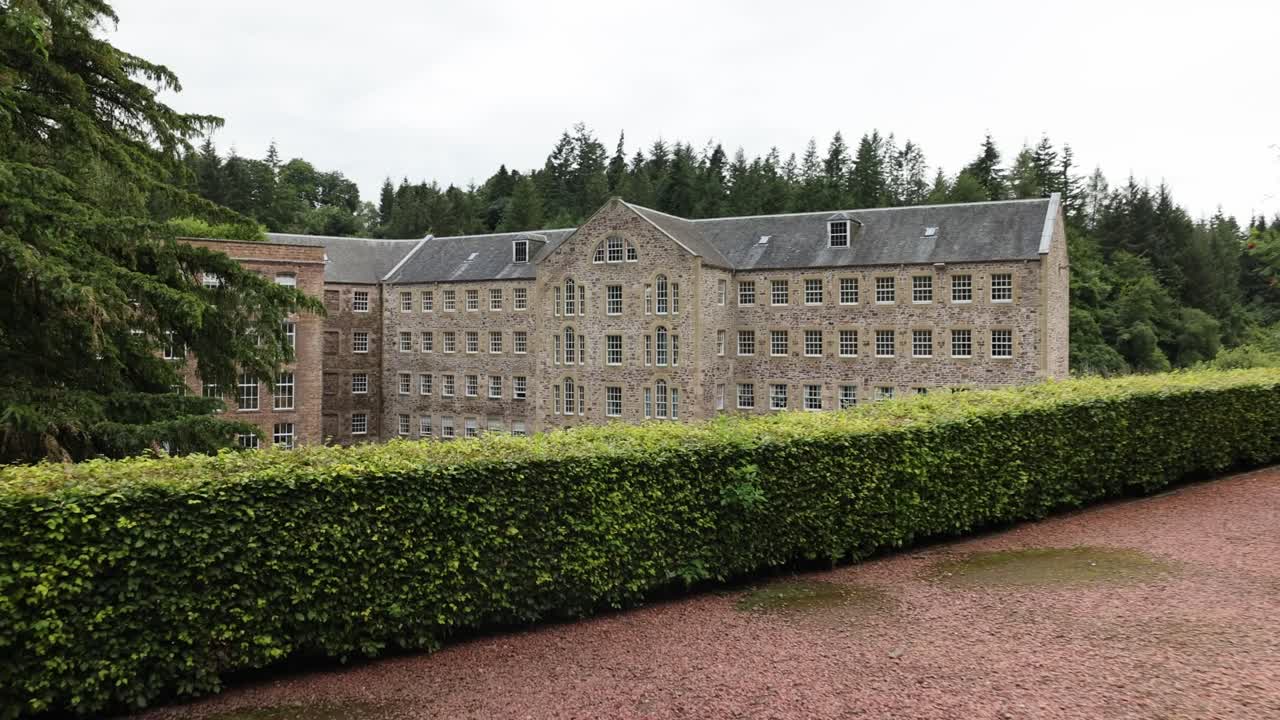 Slow dolly shot towards the UNESCO famous New Lanark Mill Hotel