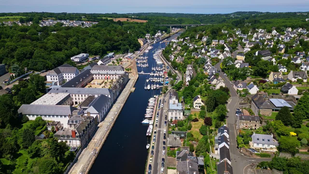 Panorama drone view of the Morlaix River aka Rivière de Morlaix winding between houses and local buildings, Brittany, France.