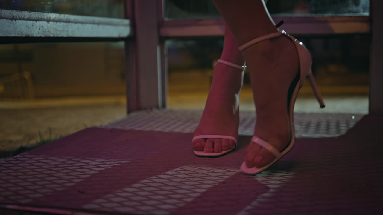 High-heels woman legs standing night city closeup. Unknown party lady posing