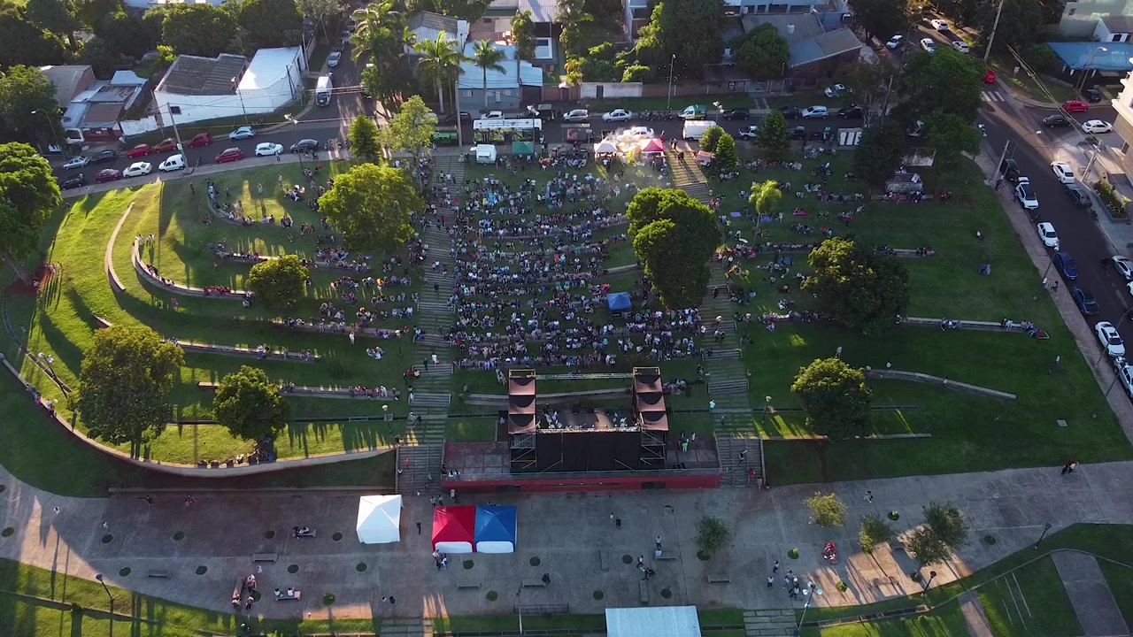 Wide angle aerial shot of Posadas Anfiteatro El Brete festival area in Argentina with concert visitors in city park