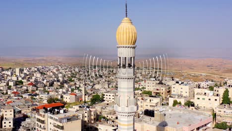 aerial view of a mosque minaret and cityscape