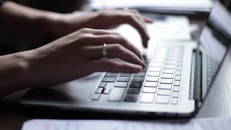 focused hands typing on a laptop keyboard in a cozy workspace, reflecting modern productivity and digital connectivity in the contemporary world
