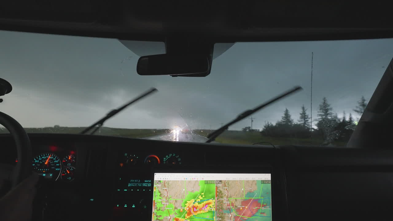 Storm Chasers Driving Through Heavy Rain With On Coming Vehicle Head Lights