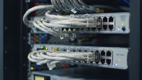 close-up view of network switches in a data center filled with various cables and connectors, highlighting the complexity of digital communication technology in action.