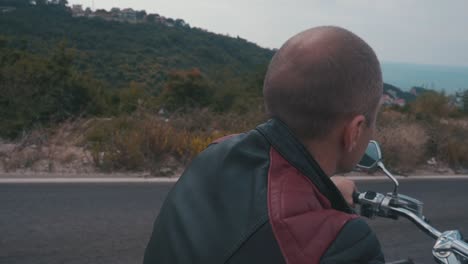 motociclista en un pintoresco camino de montaña