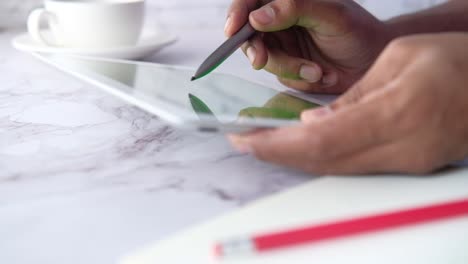 Person using a stylus on a tablet