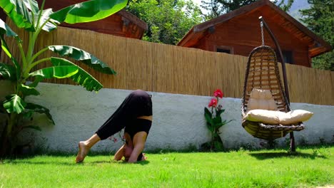 there is a girl doing yoga in the forest bungalow at home green