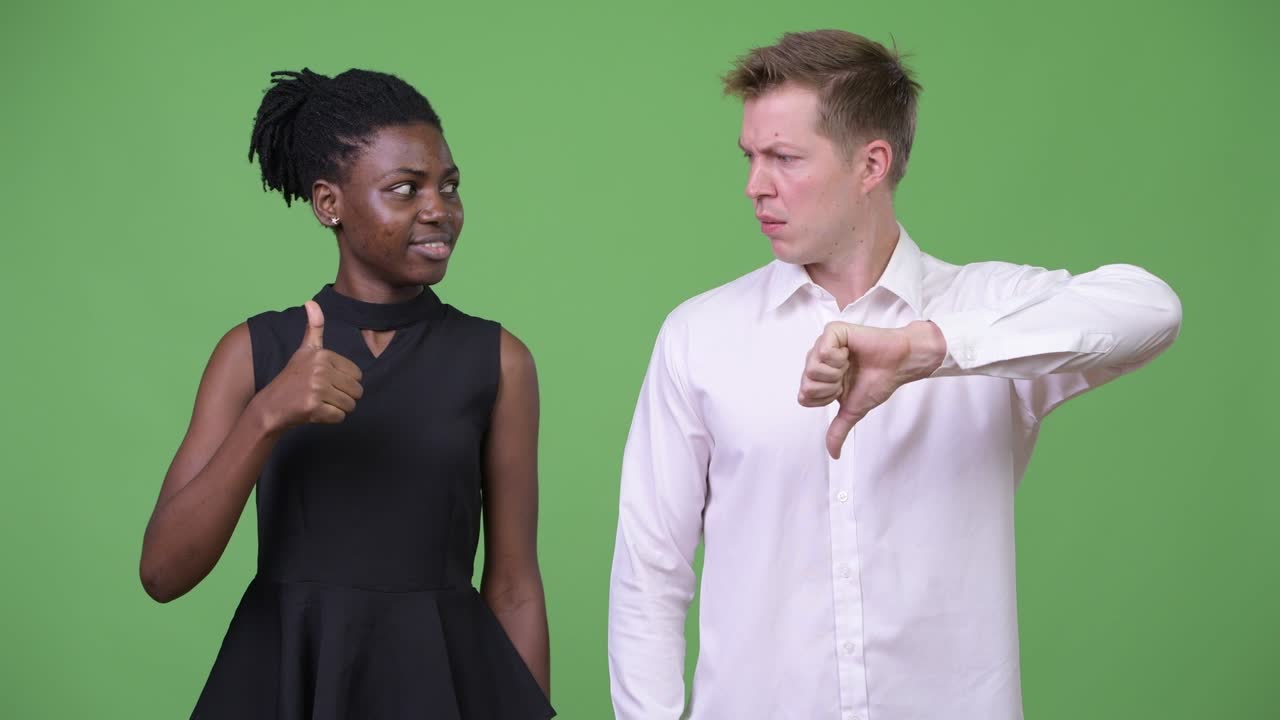 Two young multi-ethnic business couple having different choices together