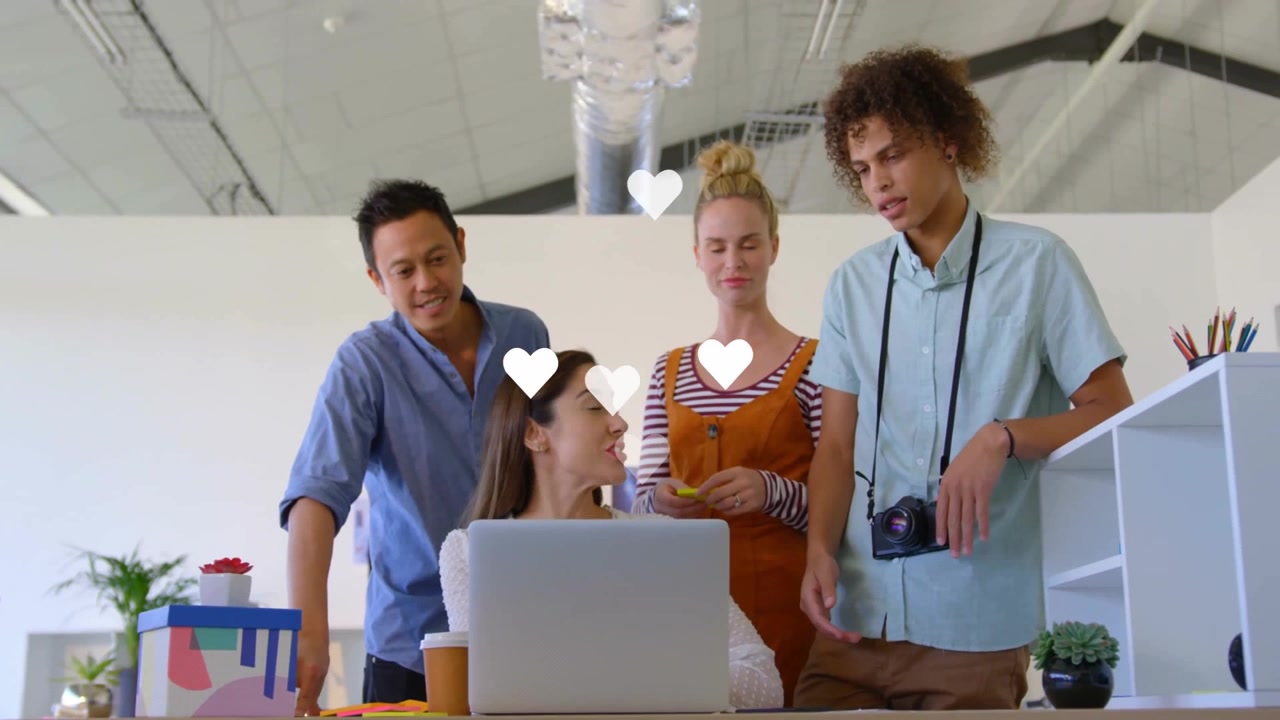 Diverse Creative Team Collaborating on Laptop in Modern Office