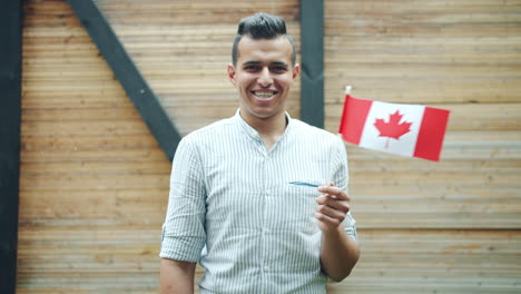 man smiling with canadian flag