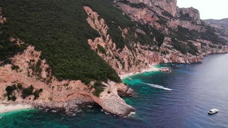 aerial crane shot of rocky coast in the mediterranean sea, sardinia