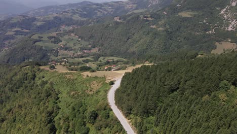 aerial view of lonely road path in pine tree green forest in tara national in serbia mountain landscape